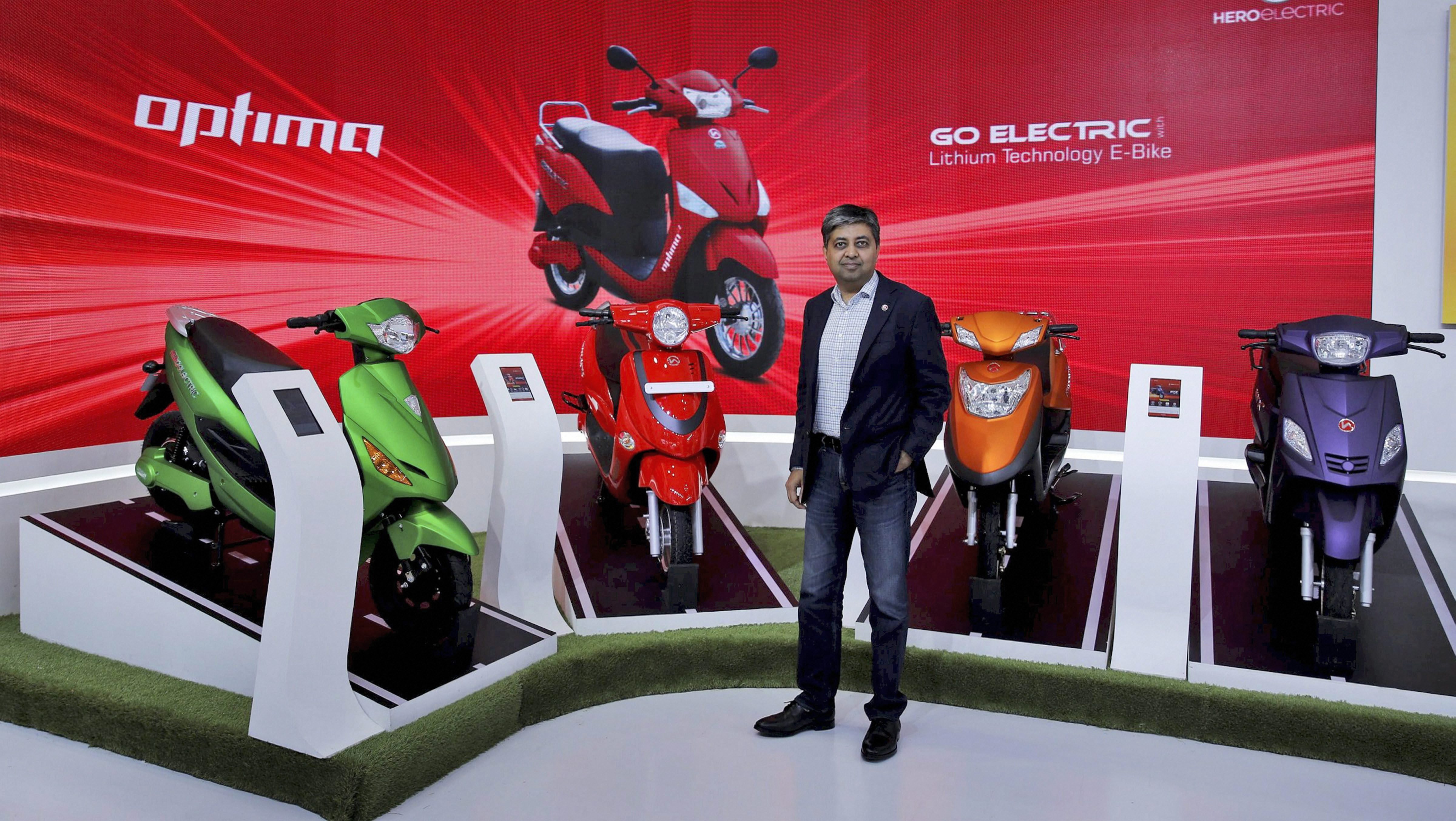 Greater Noida: Naveen Munjal, MD of Hero Electric unveils company''s new range of electronic two-wheelers during the Auto Expo. PTI