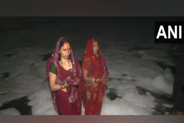 Delhi: Devotees stand in knee-deep toxic foam in Yamuna for Chhath Puja