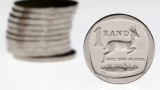 South African rand slightly stronger against muted dollar